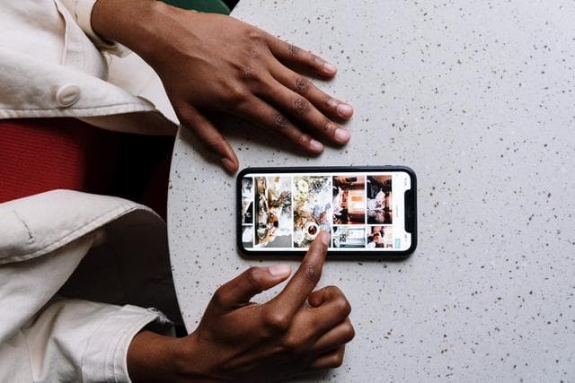 women scrolling on phone with screen showing images