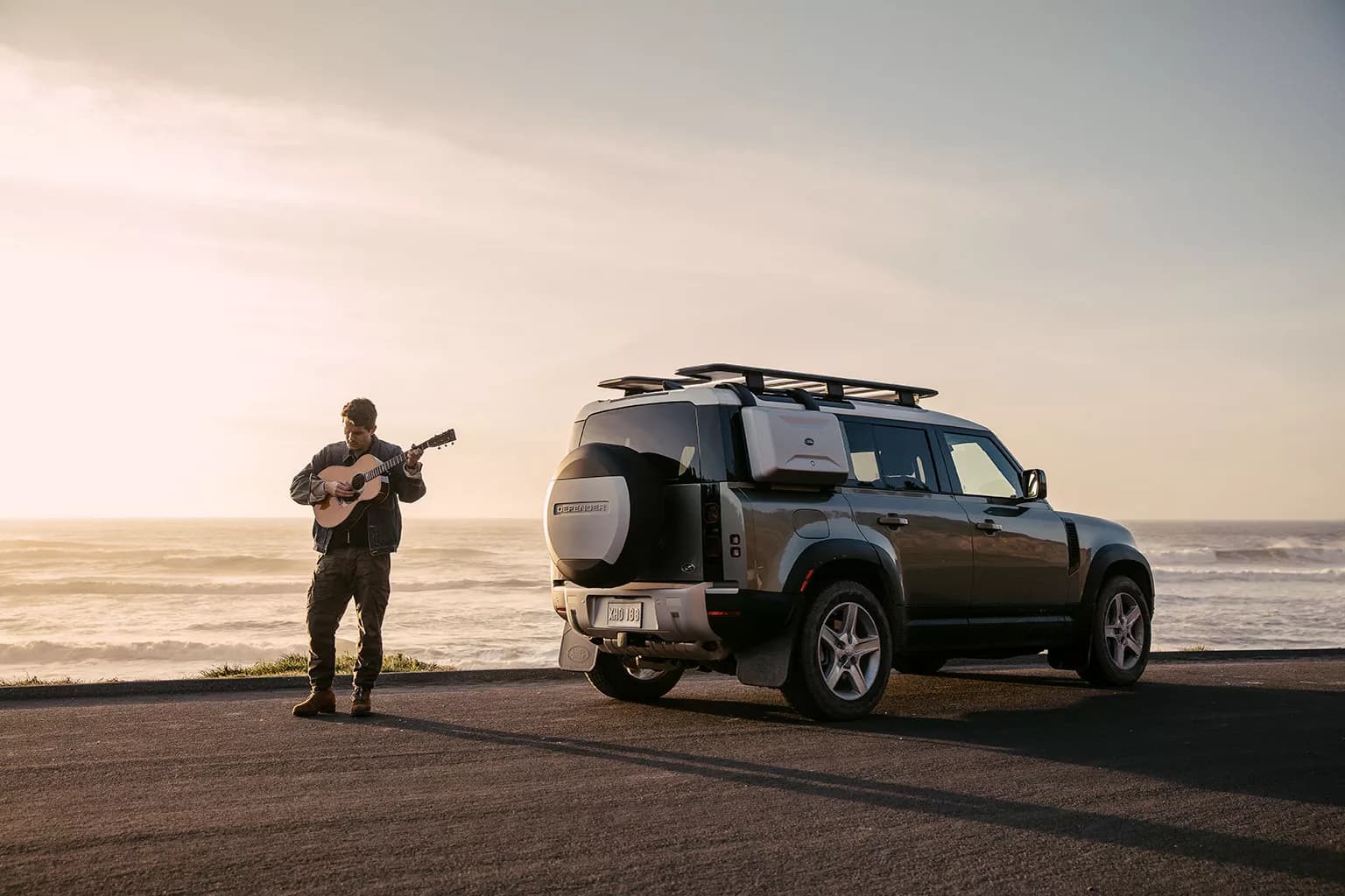 John Mayer with Land Rover Defender by the coast